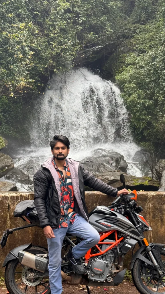 Amar Karthik standing in front of his clean looking KTM 250 Duke Motorcycle.