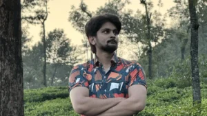 amar karthik standing confidently in a tea estate