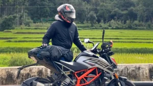 amar karthik standing behind his KTM Duke 250 motorcycle